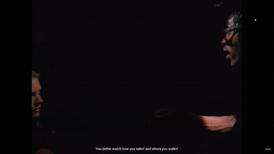 Woman In Black Coat Talking To Man In Black Suit GIF