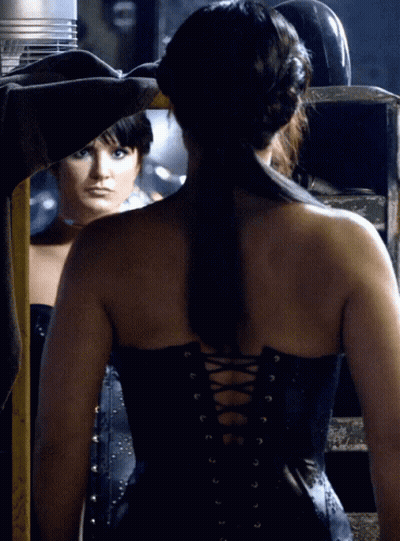 Woman In Black Corset Looking In Mirror GIF