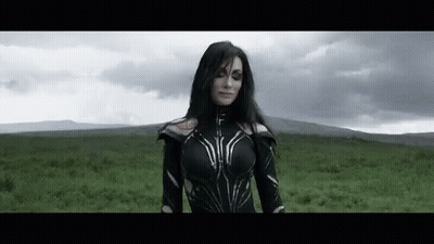 Woman In Black Costume Standing In Field GIF