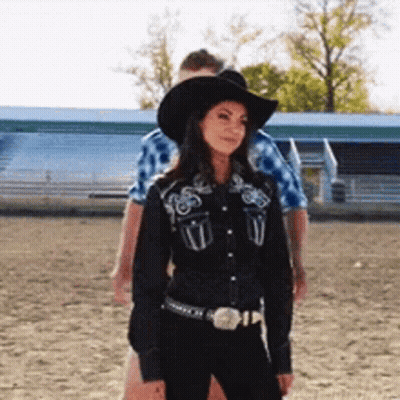 Woman In Black Cowboy Hat And Black Shirt GIF