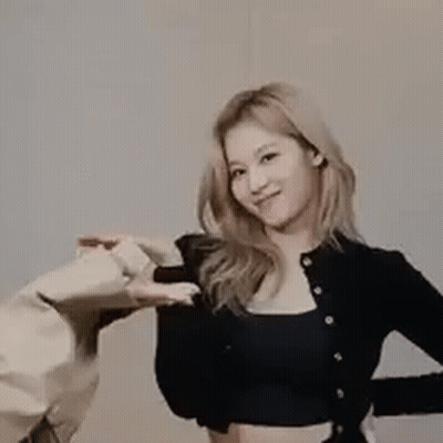 Woman In Black Crop Top Next To Man In Beige Jacket GIF