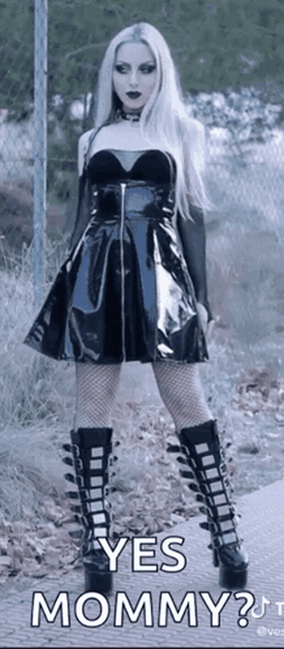 Woman In Black Dress And Boots Asking Yes Mommy GIF