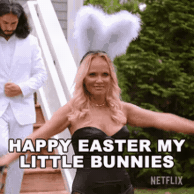 Woman In Black Dress And Bunny Ears Dancing While Man In White Suit Looks On GIF
