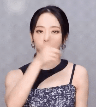 Woman In Black Dress And Earrings Gesturing GIF