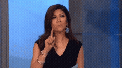 Woman In Black Dress And Earrings Pointing Funny Face GIF
