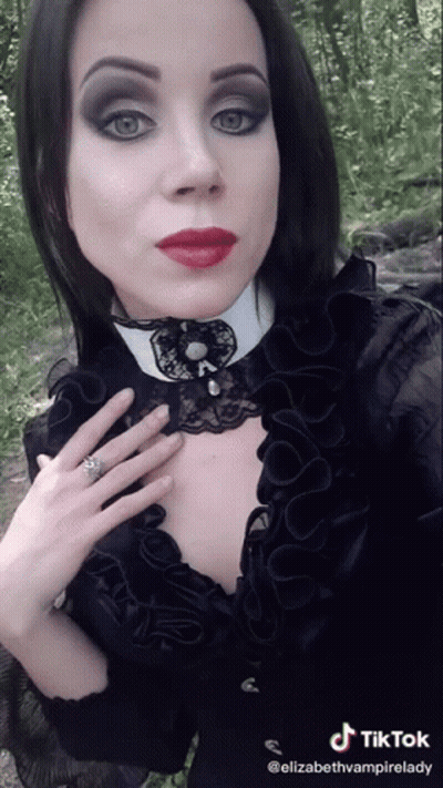 Woman In Black Dress And White Collar TikTok Watermark GIF