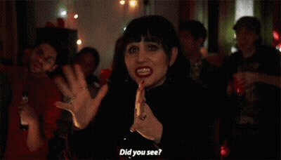 Woman In Black Dress Before Crowd GIF