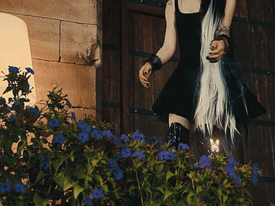 Woman In Black Dress By Wooden Door GIF
