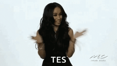 Woman In Black Dress Dancing And Smiling GIF