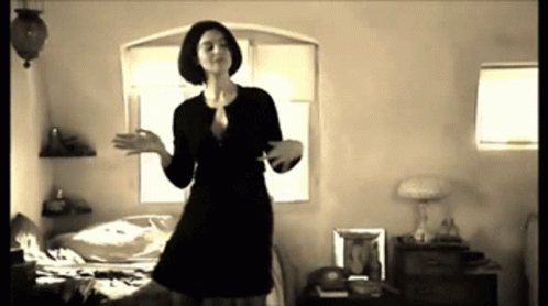 Woman In Black Dress Dancing In Bedroom GIF