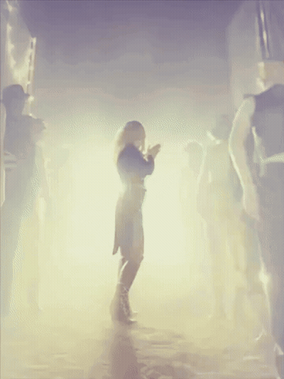 Woman In Black Dress Dancing In Crowd GIF