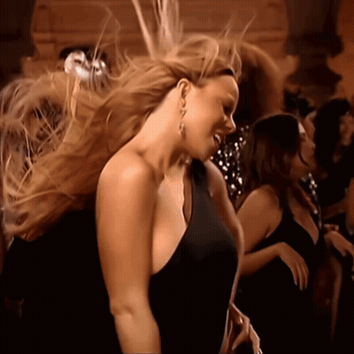 Woman In Black Dress Dancing In Crowd GIF