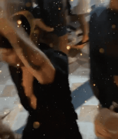 Woman In Black Dress Dancing In Dark Room GIF