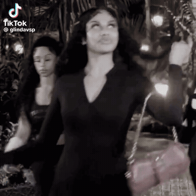 Woman In Black Dress Dancing With Pink Purse GIF