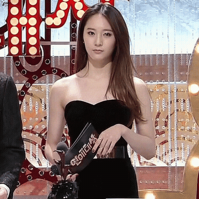 Woman In Black Dress Holding Clipboard Saying Glow GIF