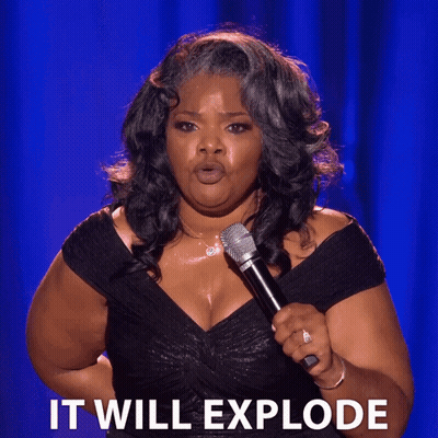Woman In Black Dress Holding Microphone Saying It Will Explode GIF