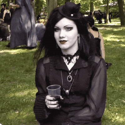 Woman In Black Dress Holding Plastic Cup GIF