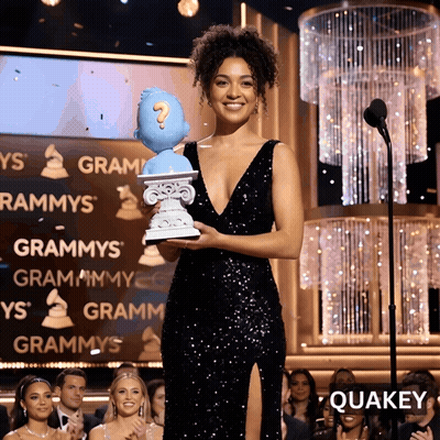 Woman In Black Dress Holding Question Mark Statue GIF