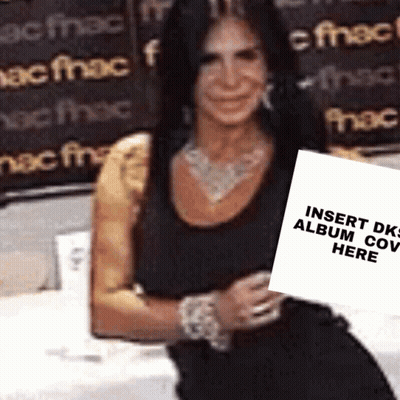 Woman In Black Dress Holding Sign Saying Insert DK Album Cover Here GIF