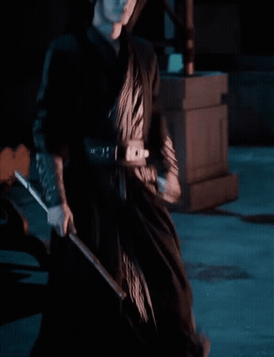 Woman In Black Dress Holding Sword GIF