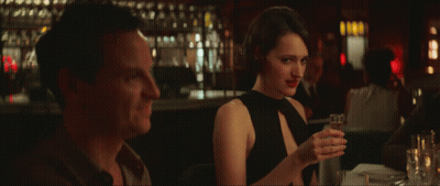 Woman In Black Dress Holding Wine Glass Next To Man GIF