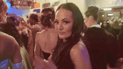 Woman In Black Dress In Crowd Of Women GIF