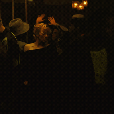 Woman In Black Dress In Dark Room GIF