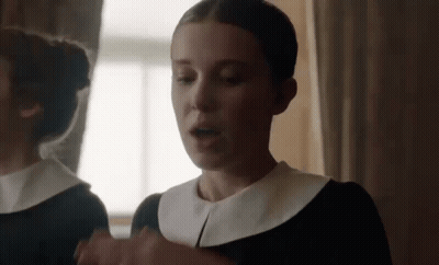 Woman In Black Dress In Front Of Mirror GIF