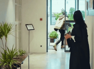 Woman In Black Dress In Front Of No Smoking Sign GIF