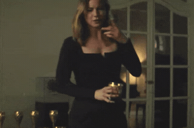 Woman In Black Dress In Front Of Window GIF
