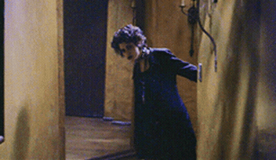 Woman In Black Dress In Hallway GIF