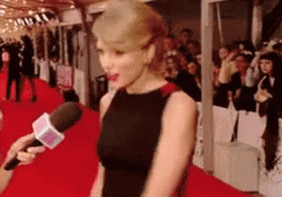 Woman In Black Dress Interviewed On Red Carpet GIF