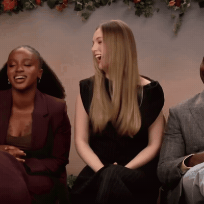 Woman In Black Dress Laughing Beside Man In Suit GIF