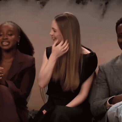Woman In Black Dress Laughing With Two People GIF