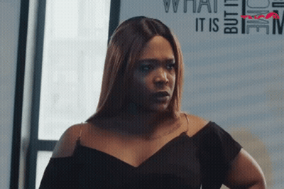 Woman In Black Dress Looking At Camera GIF