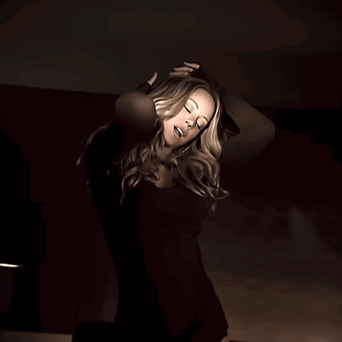 Woman In Black Dress Looking At Camera GIF