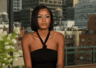 Woman In Black Dress Looking At Camera GIF