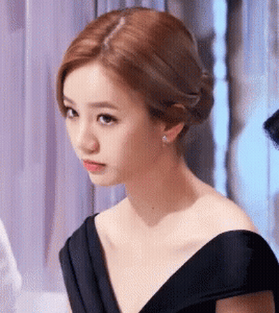 Woman In Black Dress Looking Serious GIF