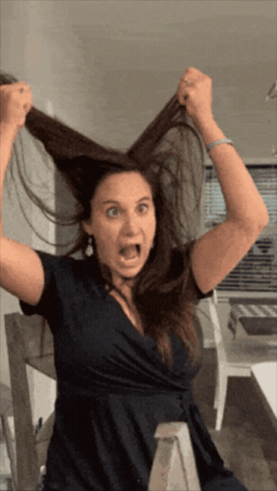Woman In Black Dress Making Funny Face GIF