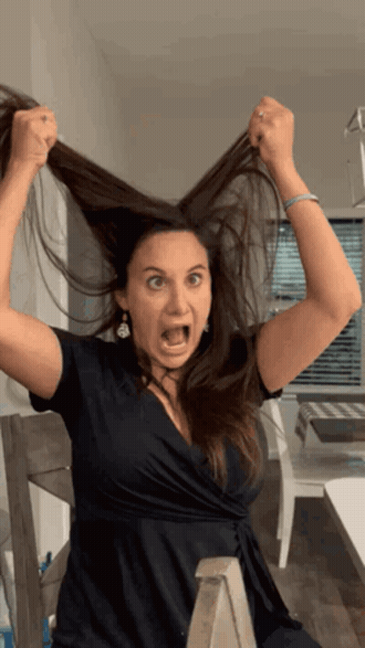 Woman In Black Dress Making Funny Face GIF