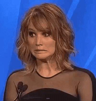 Woman In Black Dress Making Funny Face GIF