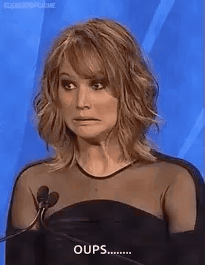 Woman In Black Dress Making Funny Face At Microphone GIF