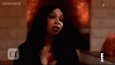 Woman In Black Dress Making Funny Face In Dark Room GIF