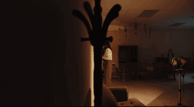 Woman In Black Dress Making Funny Face With Hands Up GIF
