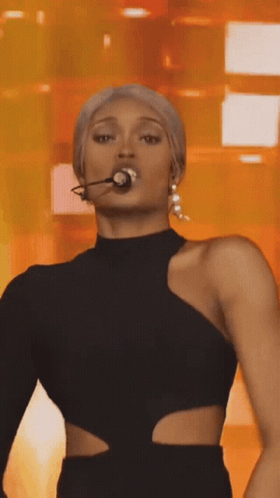 Woman In Black Dress Microphone In Mouth GIF