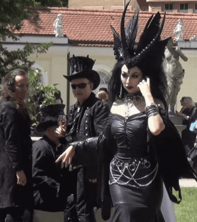 Woman In Black Dress Next To Man In Top Hat GIF