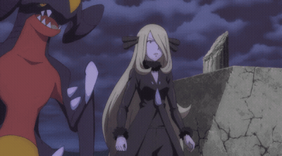 Woman In Black Dress Next To Red And Yellow Monster GIF