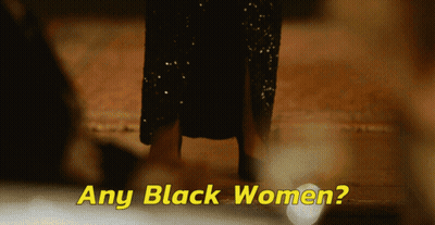 Woman In Black Dress Next To Words GIF