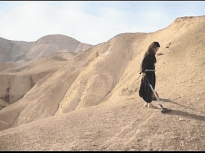 Woman In Black Dress On Desert Hill GIF