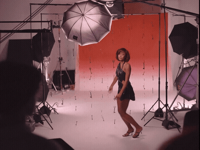 Woman In Black Dress On Red Background GIF